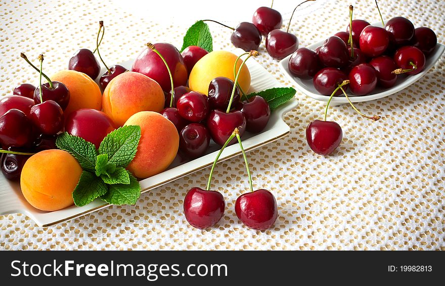 Plate with fruits, cherries, apricots, plums and mint. Plate with fruits, cherries, apricots, plums and mint.