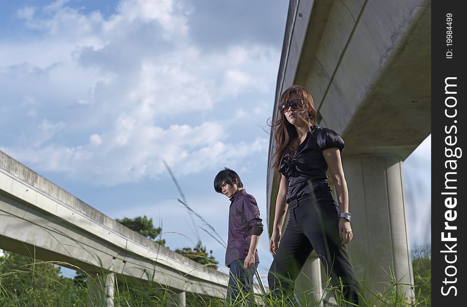 Asian Couple walking near rail track