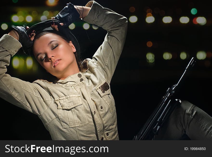 Young beauty girl with machine-gun on black background. Young beauty girl with machine-gun on black background