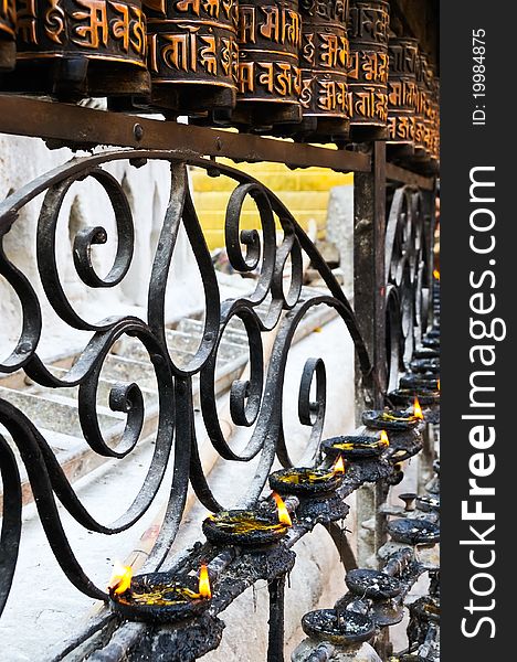 Buddhist prayer wheels and candles in Nepal