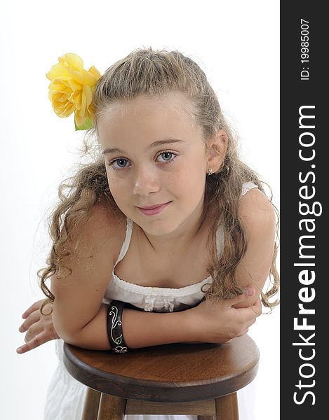 White beautiful child posing with yellow rose in studio. White beautiful child posing with yellow rose in studio