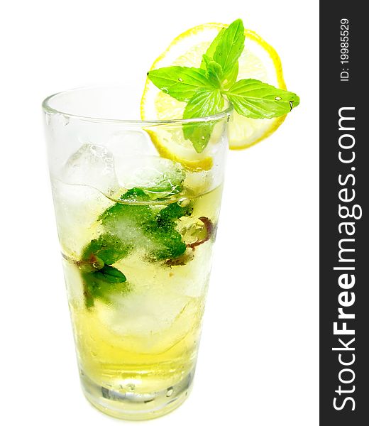 Glass of fruit yellow lemonade with ice and mint