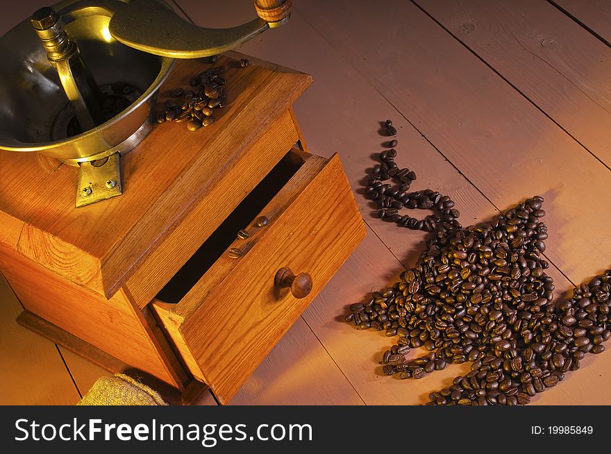 Coffee grinder and coffee beans on the table. Coffee grinder and coffee beans on the table