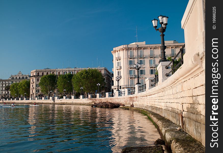 Embankment with a parapet in the foreground and buildings in the background