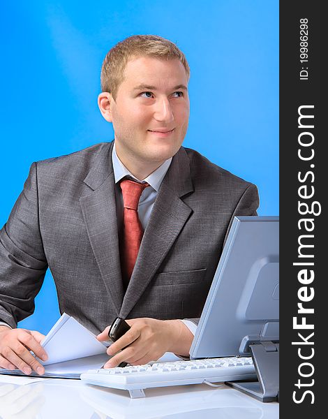 Young successful business man with a document case and computer