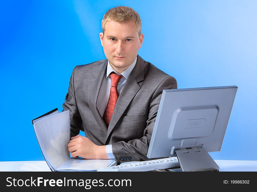 Young successful business man with a document case and computer