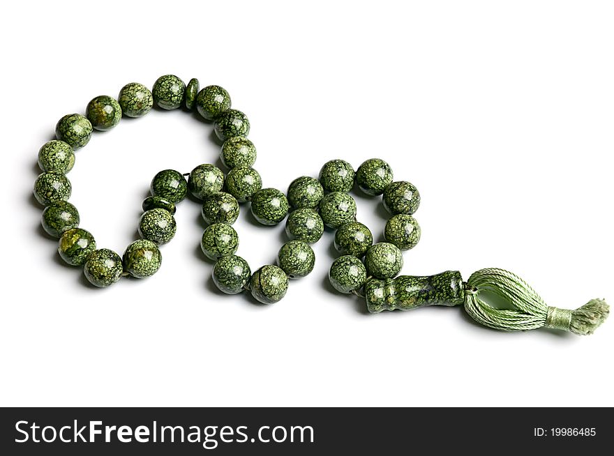 Rosary of serpentine stone isolated on white background