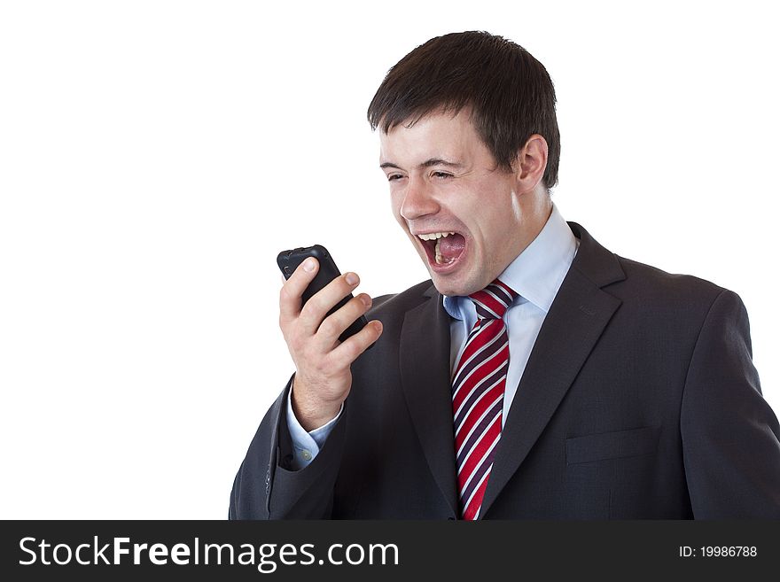 Annoyed young businessman shouts aloud in cell phone. Isolated on white background. Annoyed young businessman shouts aloud in cell phone. Isolated on white background.