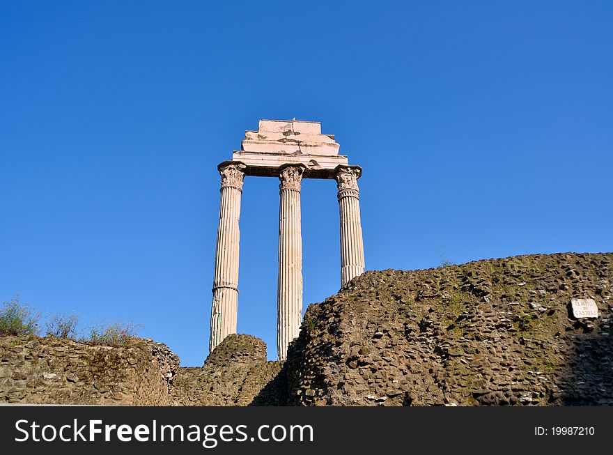 Ancient marble columns against a blue sky. Rome, Italy. Ancient marble columns against a blue sky. Rome, Italy