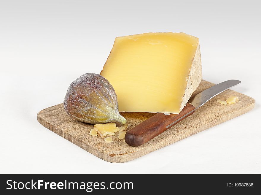 Cheese and fig on small wooden cutting board. Cheese and fig on small wooden cutting board