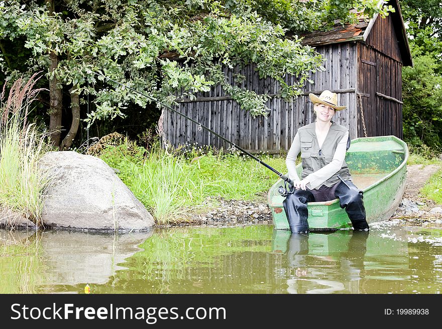 Fishing woman sitting on boat