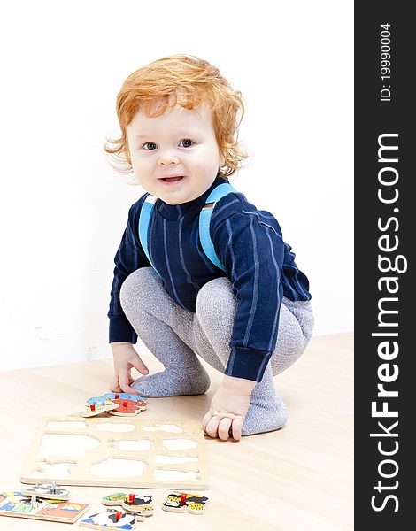 Little boy playing with puzzle