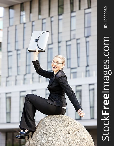 Sitting young businesswoman with a briefcase