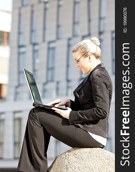 Sitting young businesswoman with a notebook
