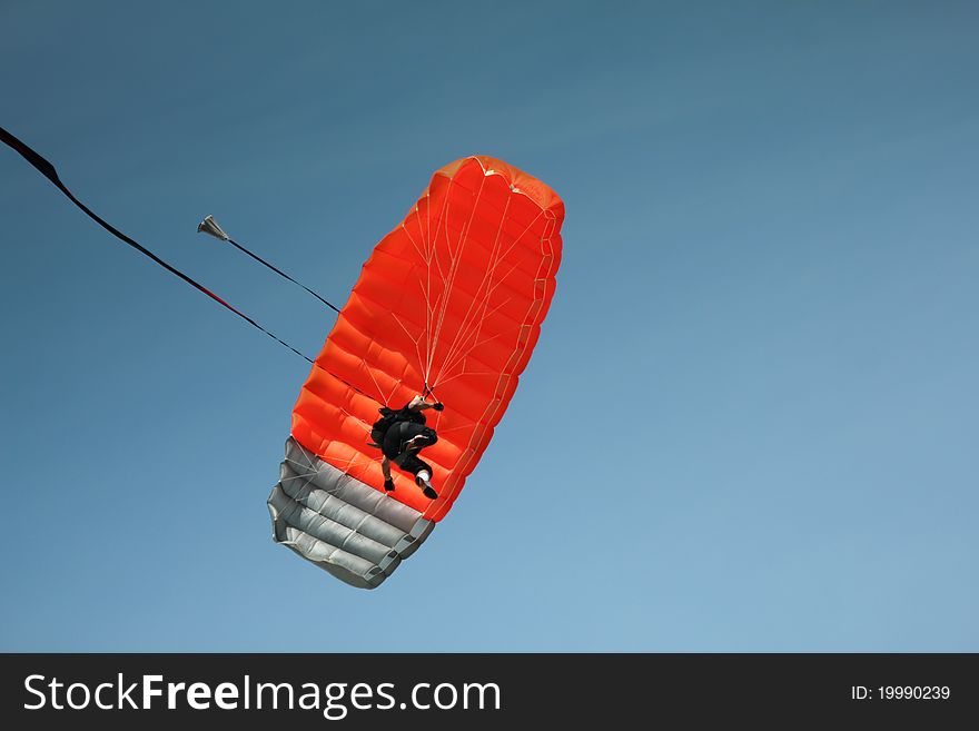 Parachutist descends fro a clear blue sky. Parachutist descends fro a clear blue sky