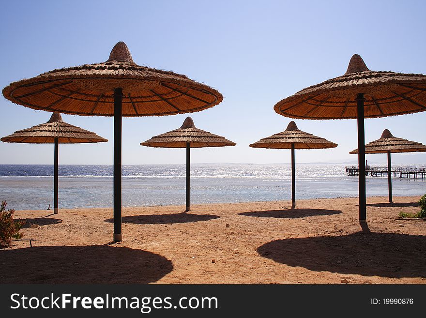 Sandy beach, parasols and sea - Nabq Bay near Sharm El Shaikh, Egypt, Sinai. Sandy beach, parasols and sea - Nabq Bay near Sharm El Shaikh, Egypt, Sinai