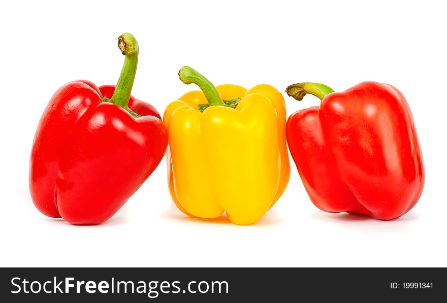 Two Reds and yellow sweet peppers isolated on the white background