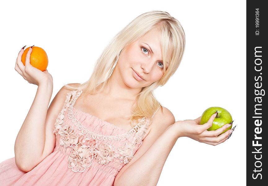 Young beautiful blonde girl choosing between apple and orange. Isolated on white background. Young beautiful blonde girl choosing between apple and orange. Isolated on white background