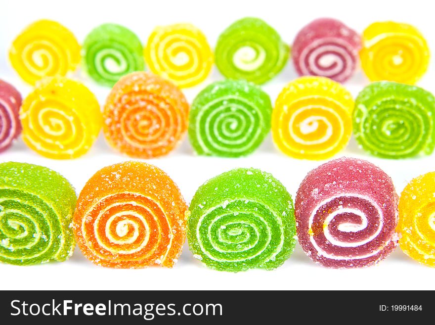 Colorful jelly in sugar on a white background