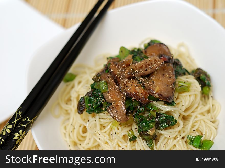 Oriental style mushroom noodles served with healthy ingredients. Oriental style mushroom noodles served with healthy ingredients.