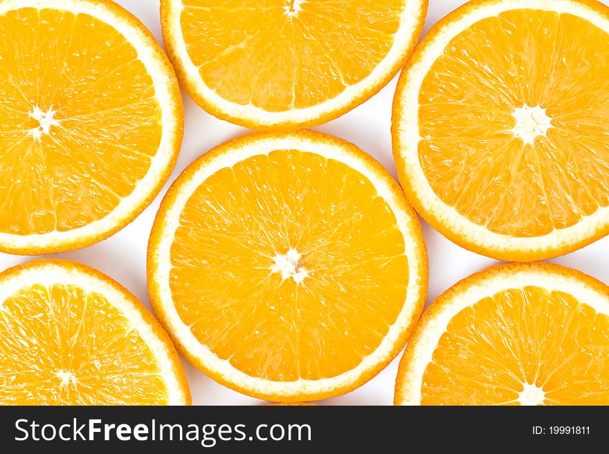 Oranges, cut into slices laid on a white background. Oranges, cut into slices laid on a white background