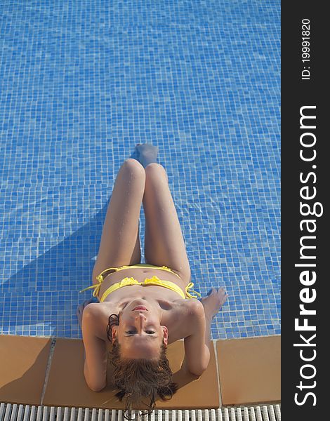 Relaxing woman in swimming pool - shot from above