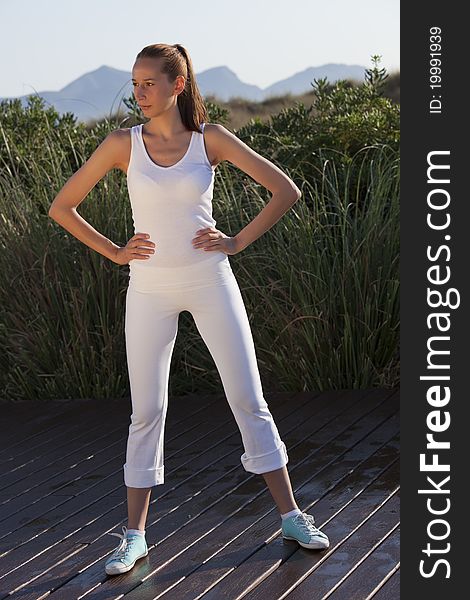 Fitness woman in white posing after workout