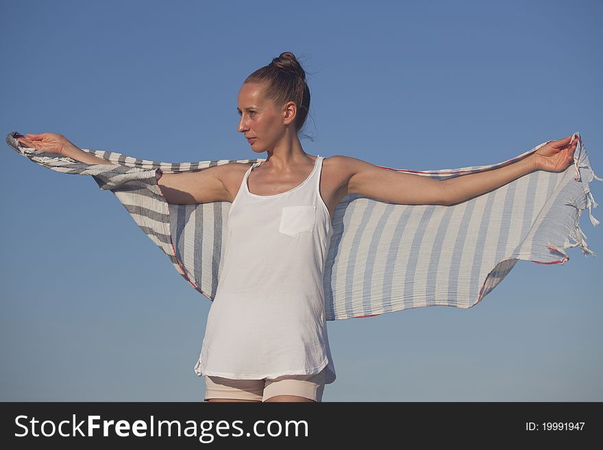 Woman with kerchief posing over blue sky