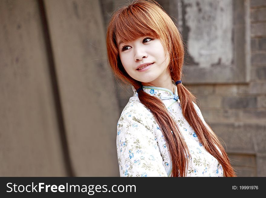 Chinese girl in traditional dress smiling outdoor. Chinese girl in traditional dress smiling outdoor.