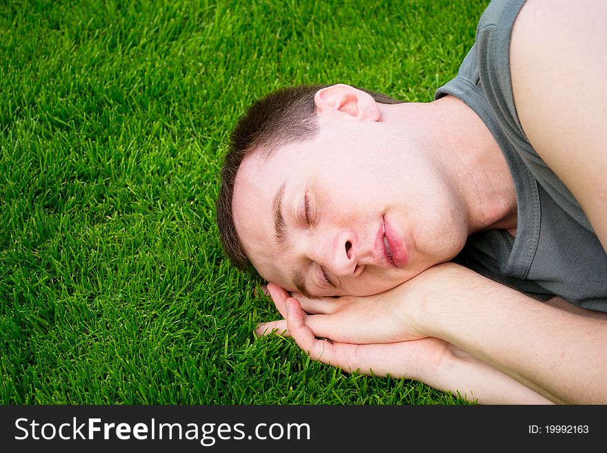 The Young Man Sleeps On  Green Grass