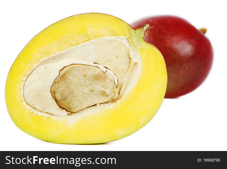 Half mango and a mango in white background. Half mango and a mango in white background