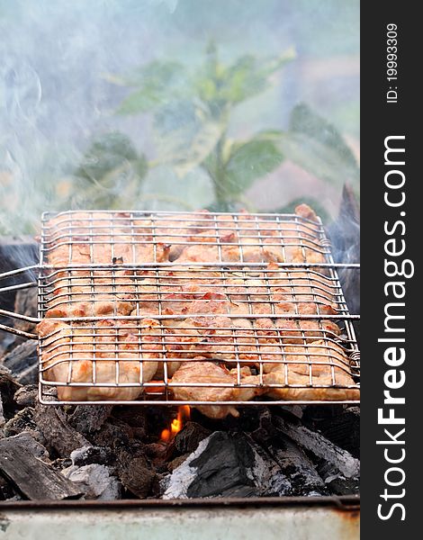 Cooking meat grilled on hot charcoal. Cooking meat grilled on hot charcoal