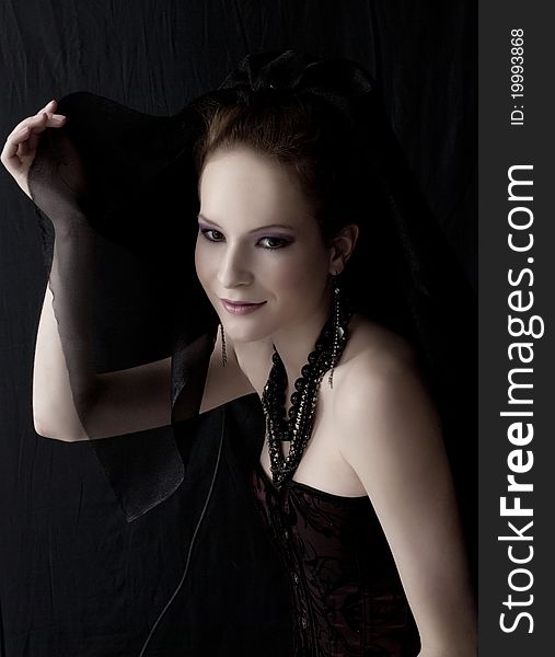 Portrait of beautiful woman in dark clothes