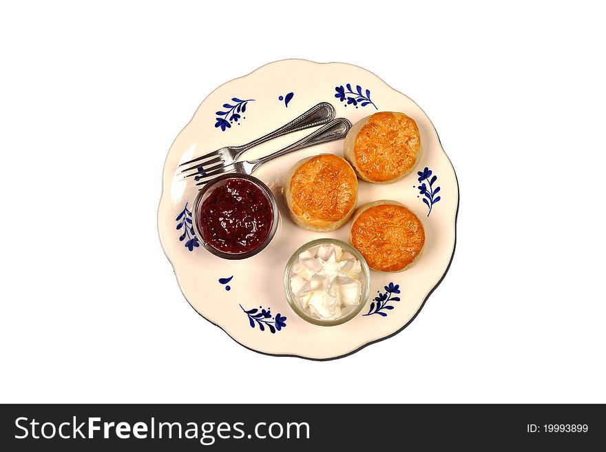 Scones on a dish with jam and cream