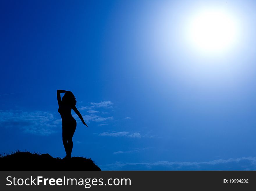 Silhouette of posing model on top of hill. Silhouette of posing model on top of hill