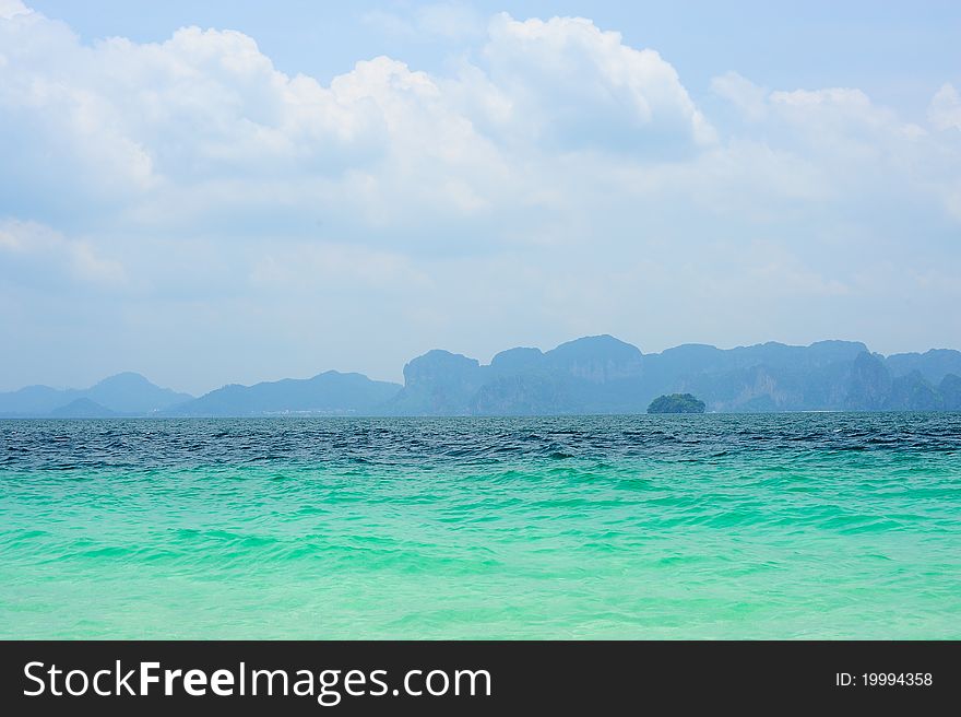 Blue sea with island in the background, Thailand