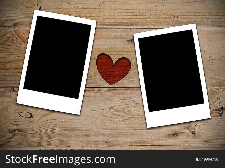 2 Instant photos with red heart on wooden wall