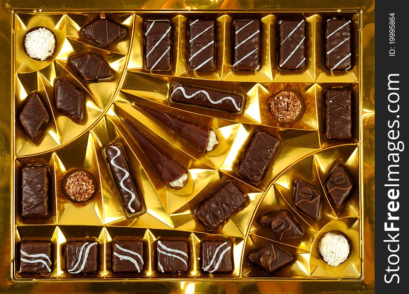 Chocolate sweets, inside a golden open box