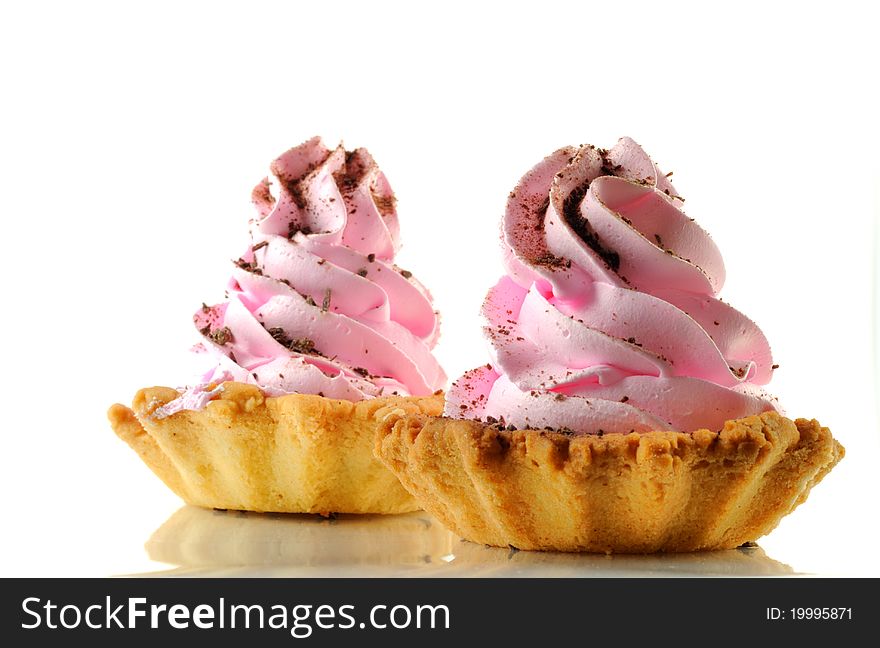 Two cupcakes with pink cream, isolated on a white background. Two cupcakes with pink cream, isolated on a white background