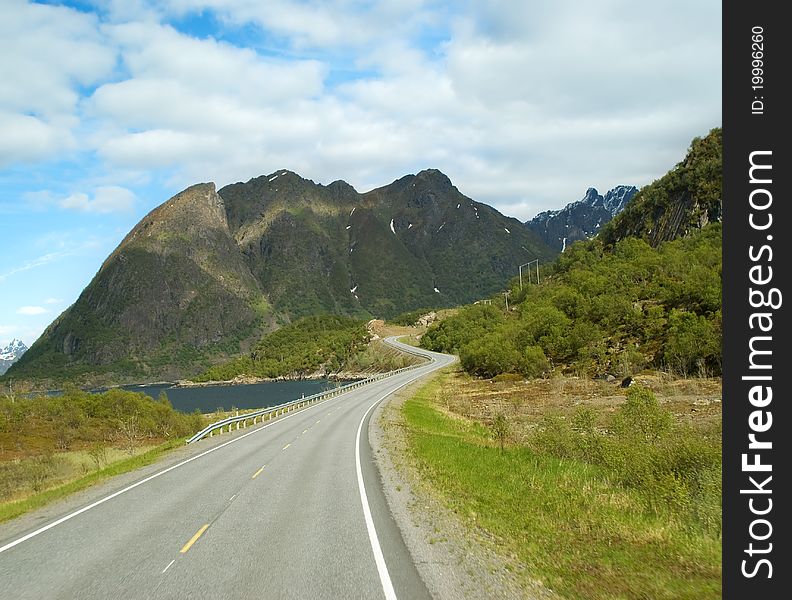 Road with cloudy sky to mountains of Norway. Road with cloudy sky to mountains of Norway