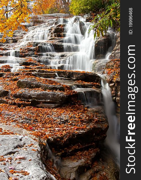 Northeasten waterfall cascading over fallen leaves. Northeasten waterfall cascading over fallen leaves.