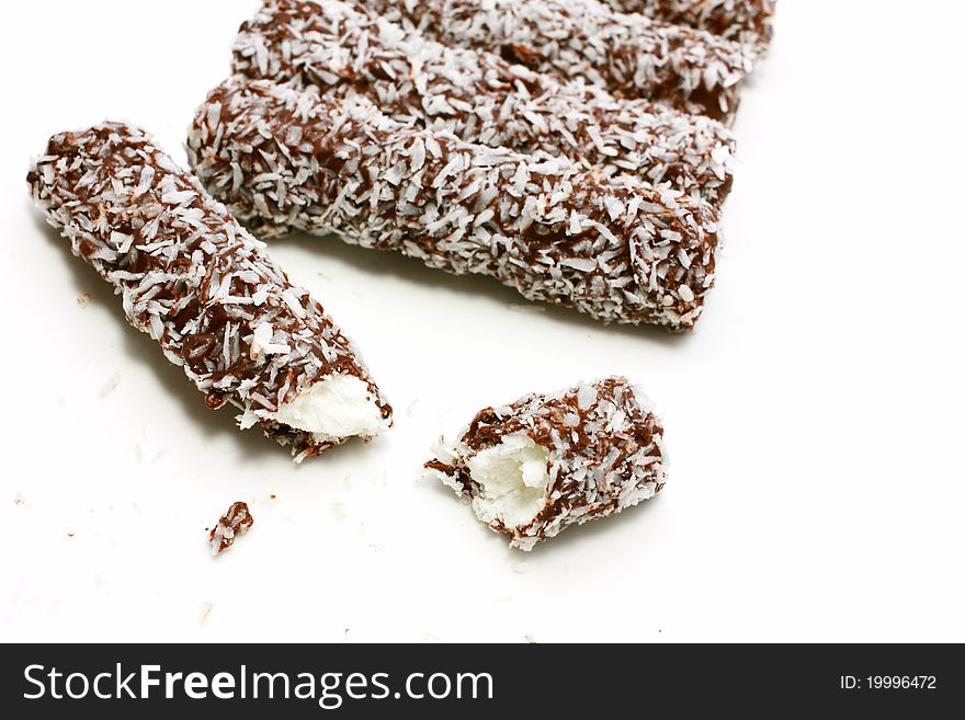 Sweet chocolate rolls with coconut close up. Sweet chocolate rolls with coconut close up