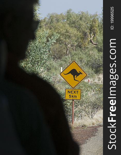 Traveler's view of warning sign for kangaroos in the Australian Outback. Traveler's view of warning sign for kangaroos in the Australian Outback