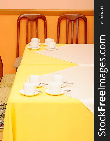 Empty coffee cups with saucers on table setting