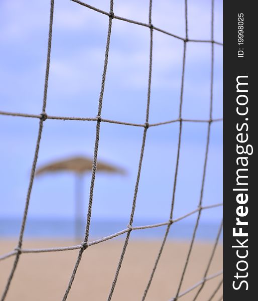 Sunshade and sand volleyball on beach, shown as enjoy holidy and sport. Sunshade and sand volleyball on beach, shown as enjoy holidy and sport.