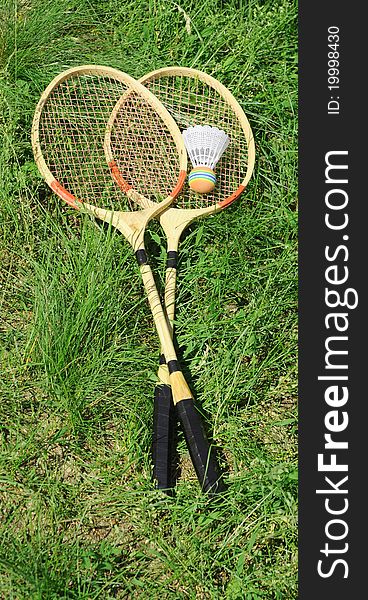 Badminton rackets on green grass