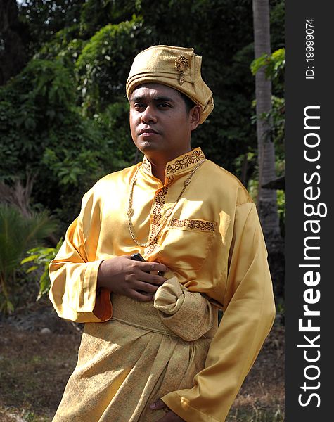 A man in traditional Malay wedding attire. A man in traditional Malay wedding attire.