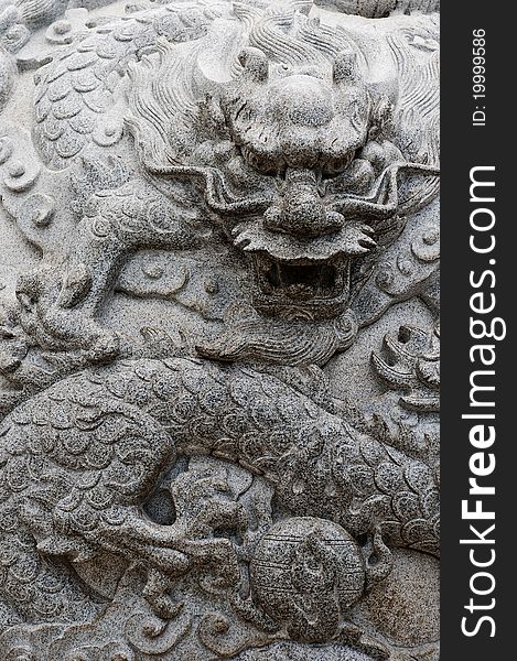 A stone carving with ancient Asian dragon theme. A stone carving with ancient Asian dragon theme