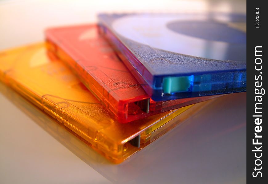 A macro / close-up of 3 coloufull Minidiscs (one Orange, one Red & one Blue). Superb macro shot.