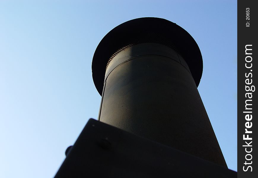 Looking upwards at a Chimmy with blue sky as the background